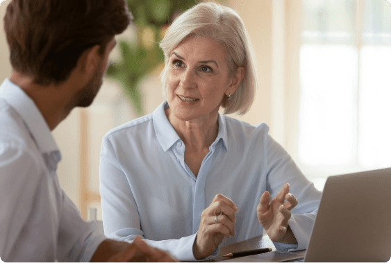 Assessor in conversation with a senior leader during a leadership assessment