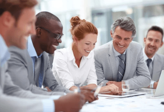 Smiling colleagues around a table during an organisational transformation workshop